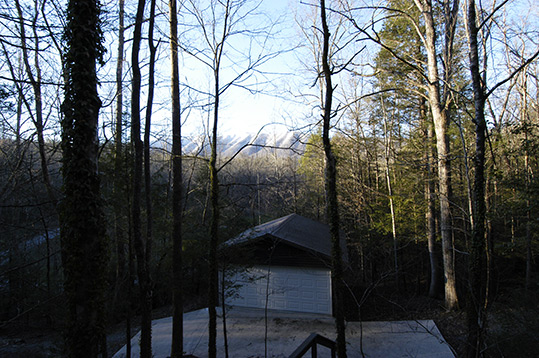 Snowy mountains behind the boat house.
