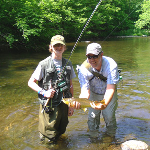 Instructor and young student with his first trout on a fly.